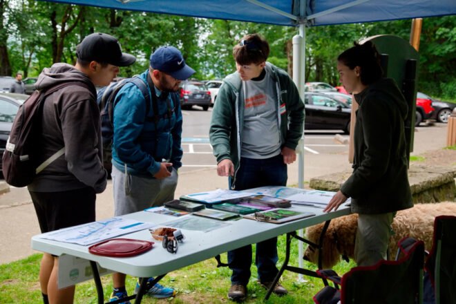 people stopping at an info booth