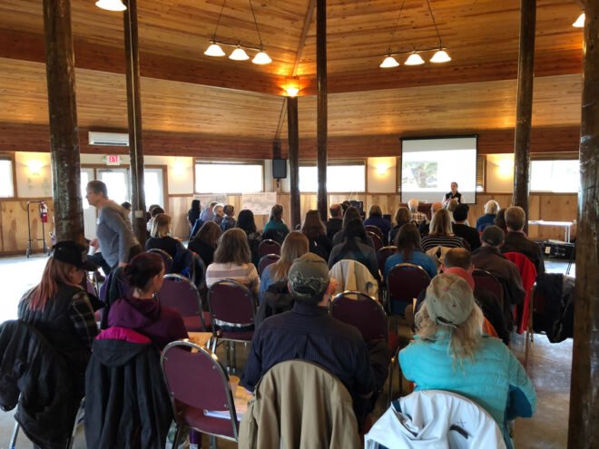 audience watching a speaker conduct a lecture