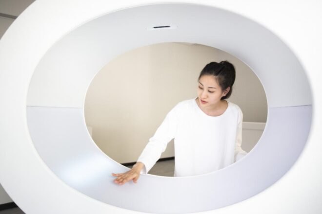 woman looks at white circular installation