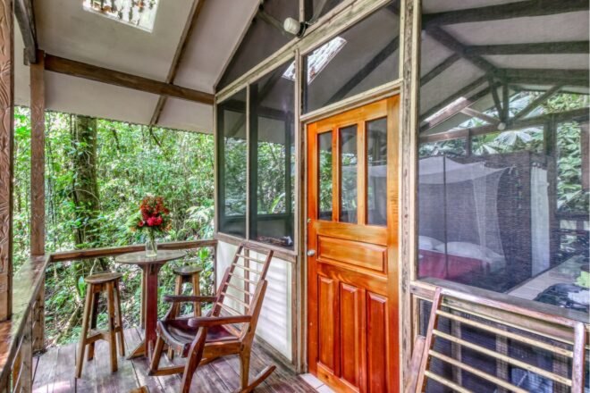 a deck outside a screen-in treehouse