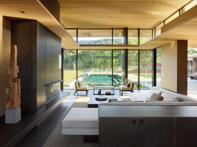home with an all glass wall looking out over the landscape