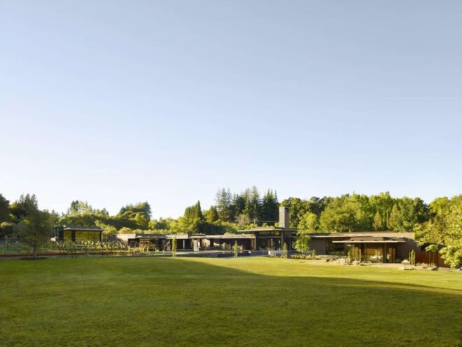 vast green lawn leading up to a house