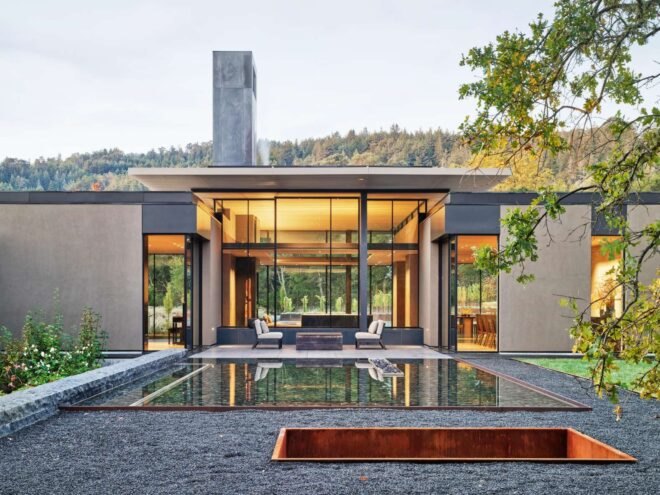 home with an all glass wall looking out over the landscape