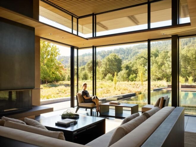 home with an all glass wall looking out over the landscape