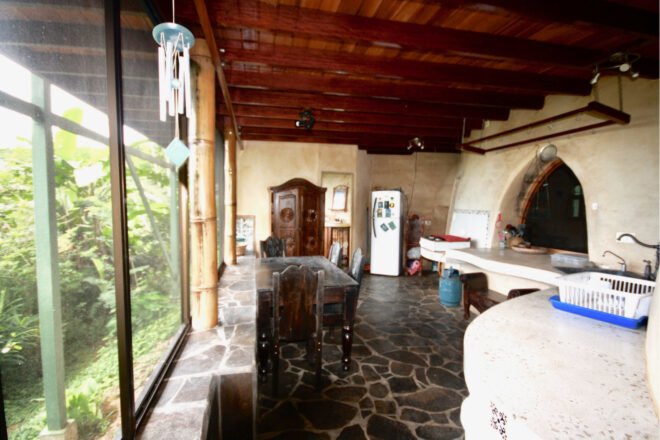 living area with stone floors and open walls