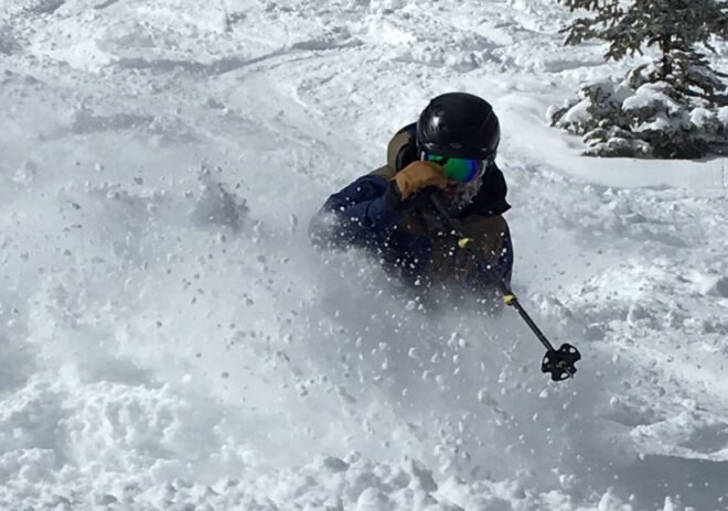 man skiing through snow