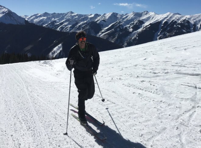 man on snowy landscape with ski poles