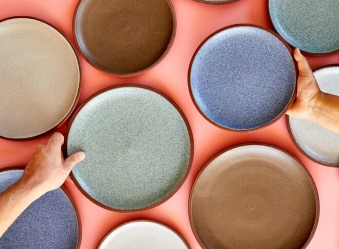 hands holding ceramic plates