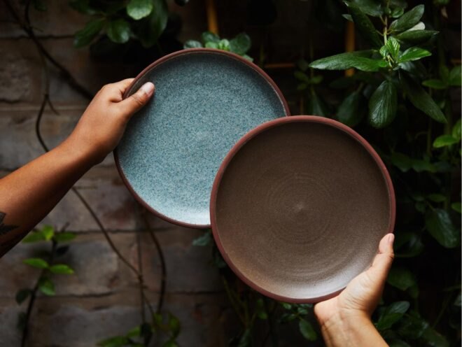 hands holding ceramic plates