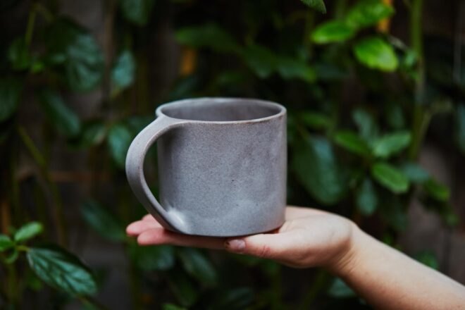 hands holding ceramic mug
