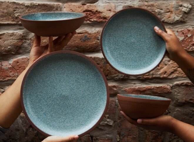 hands holding ceramic plates