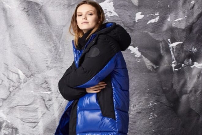 woman wearing long black and blue jacket
