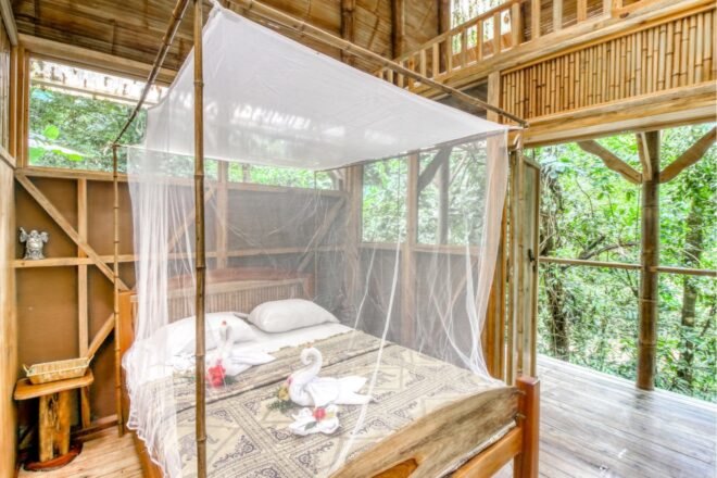 a double sized bed with mosquito netting