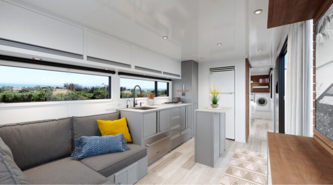 gray sofa and white kitchen in an rv