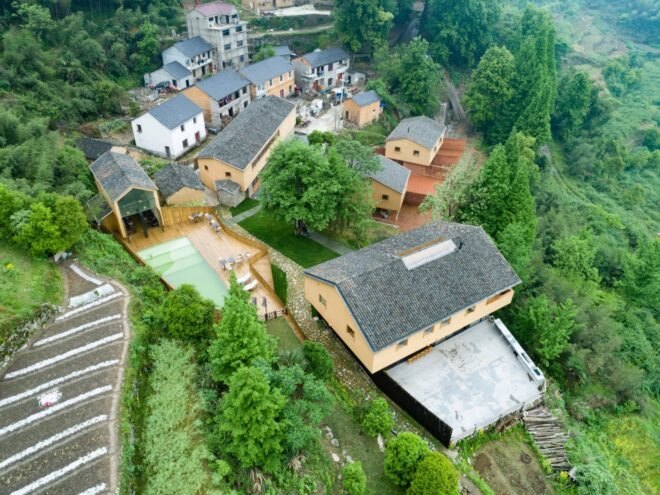 aerial view of rural eco friendly village built with raw materials surrounded by greenery