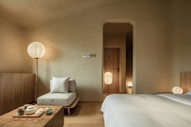 interior bedroom area with tan colored walls and wood floors