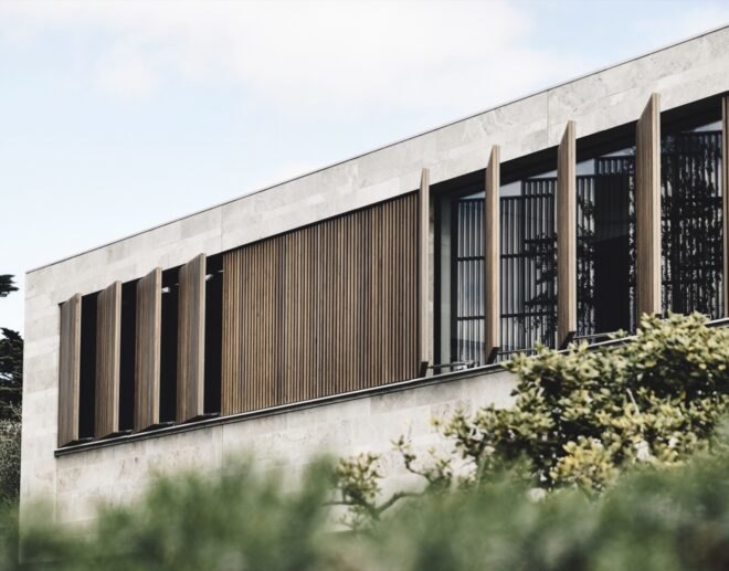 exterior view of home with windows opened surrounded by greenery