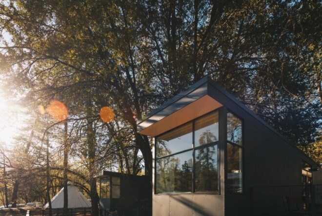 tiny black cabin with large windows