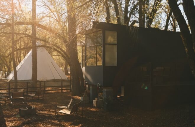 tiny black cabin with large windows