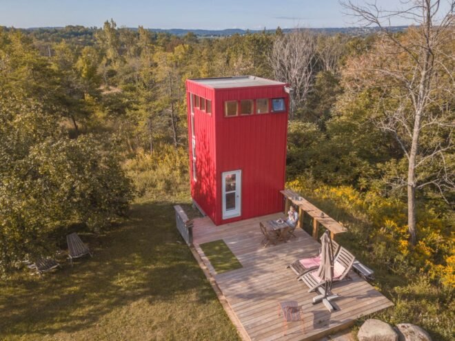 red tower with wooden deck in green field