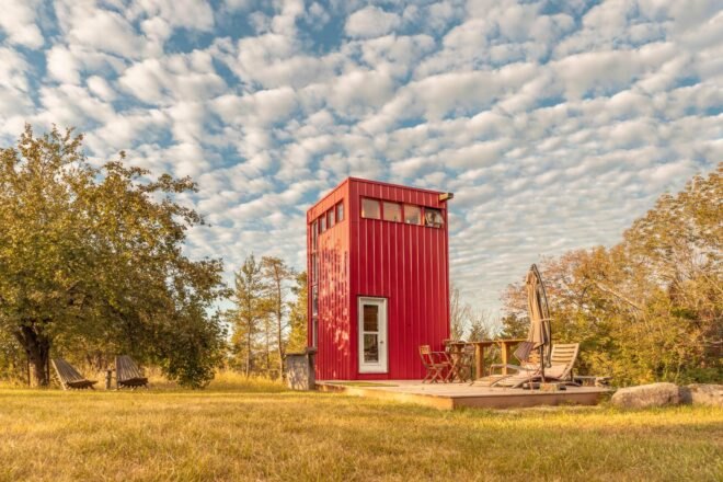 red tower with wooden deck in green field