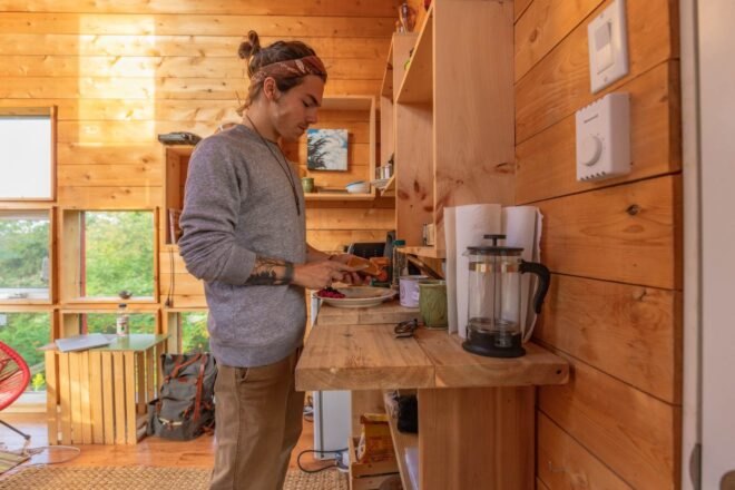 person cooking in a kitchenette