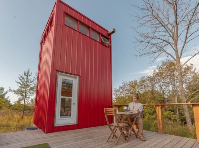 red tower with wooden deck in green field