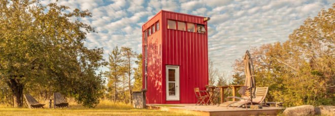 red tower with wooden deck in green field