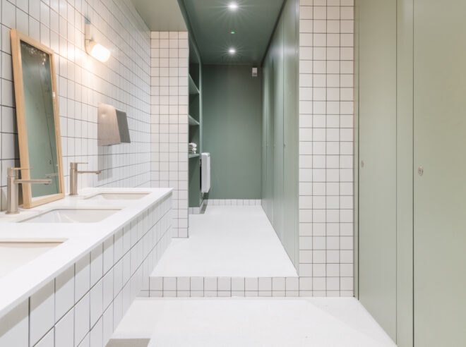 bathroom with square white tiles from top to bottom