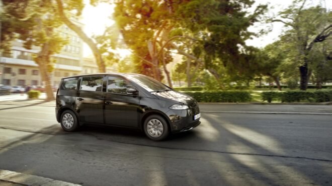 rendering of electric car driving past trees