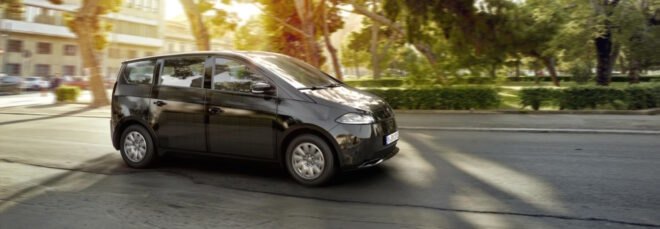 rendering of electric car driving past trees