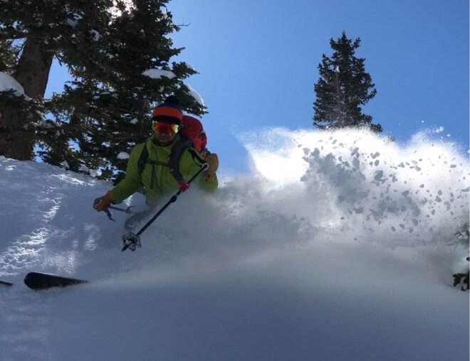 man skiing through snow