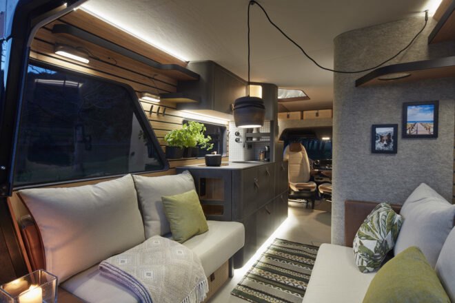 rendering of camper van with white sofas and black kitchen