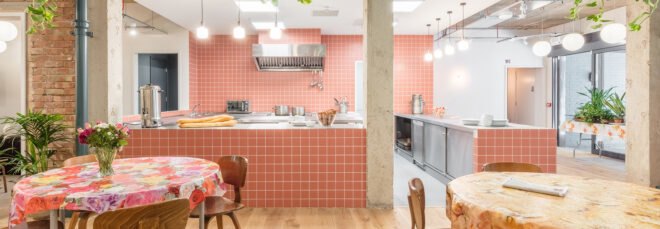 open kitchen and round tables with patterned tablecloths