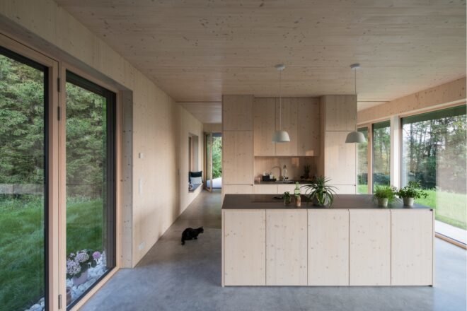 interior living space with kitchen and large glazed facades
