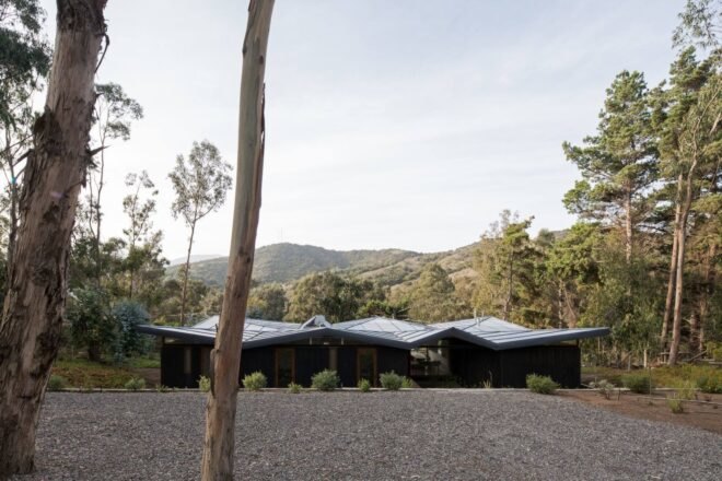 low-rise home with zigzag metal roof