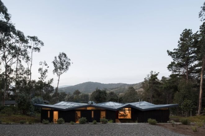 low-rise home with zigzag metal roof