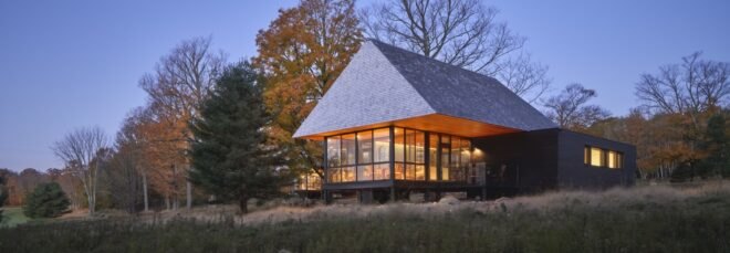cabin surrounded by greenery near lake