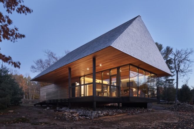 cabin surrounded by greenery near lake