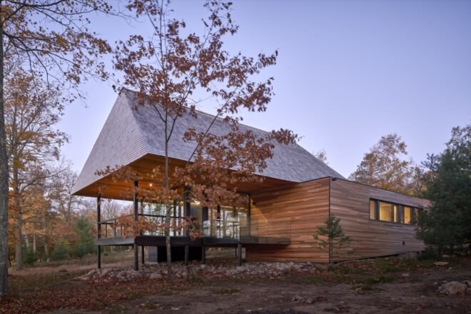 cabin surrounded by greenery near lake