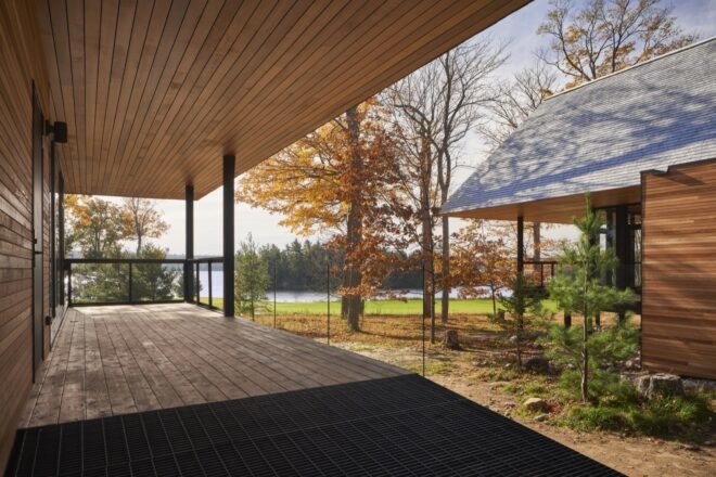 exterior wooden cabin porch with view of lake and trees