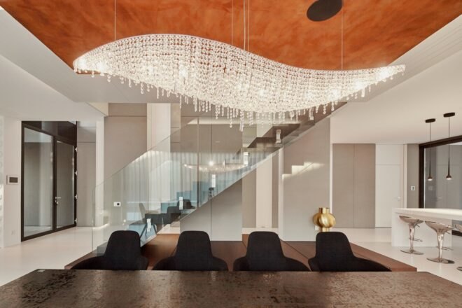 dark wood dining table under crystal chandelier