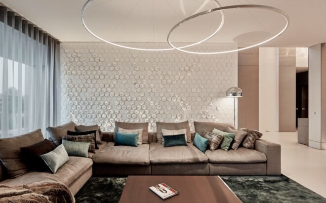 living area with round hanging lights and long gray sectional sofa
