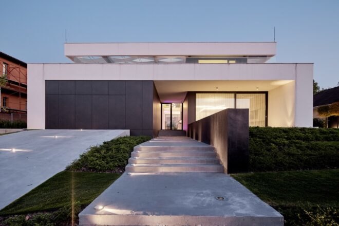 black and white home with long walkway