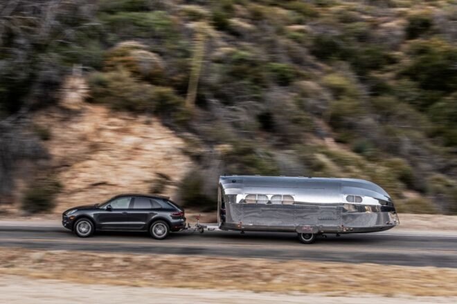SUV pulling a silver travel trailer