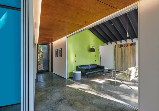 room with concrete floors and a green accent wall