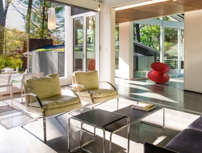 green chairs in a room with glass walls