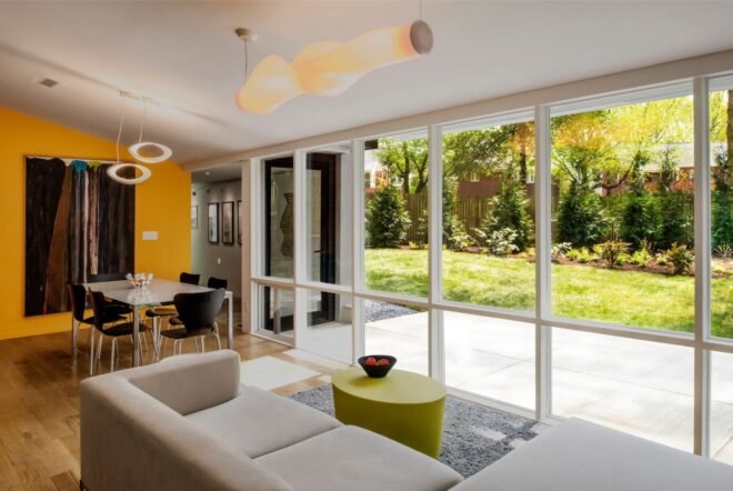 living area with white couch facing glass walls