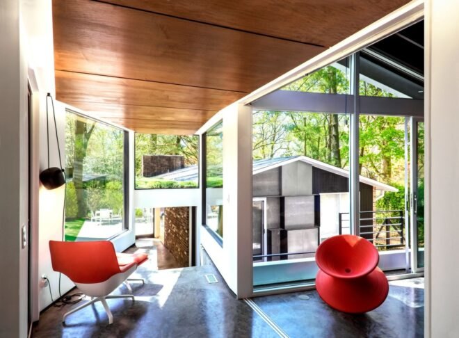 interior living space with floor-to-ceiling windows and red chairs