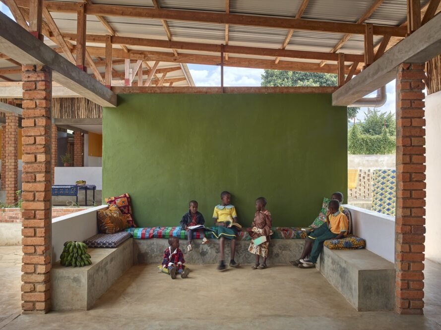 children sit inside a recreation area